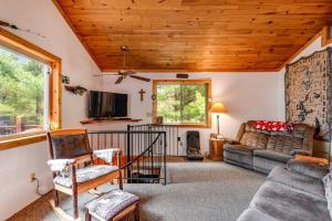 a living room with a couch and a tv at One Acre Wood in Eagle River