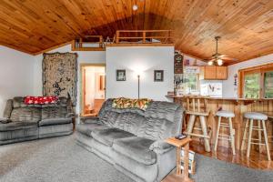 a living room with a couch and a bar at One Acre Wood in Eagle River