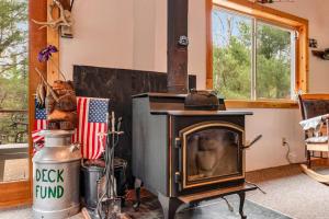 an old wood stove in a room with an american flag at One Acre Wood in Eagle River