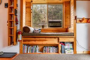 a log cabin with a window and a book shelf at One Acre Wood in Eagle River +29 photos