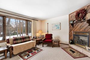 a living room with a couch and a fireplace at Cleerwood Village #252 in Eagle River