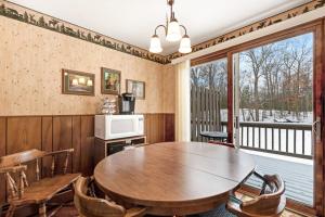 a dining room with a table and a balcony at Cleerwood Village #252 in Eagle River +22 photos