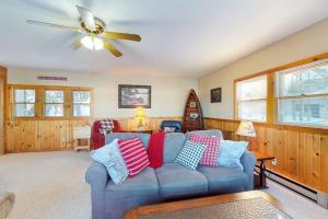 a living room with a blue couch and a ceiling fan at Briar's Hideaway in Phelps