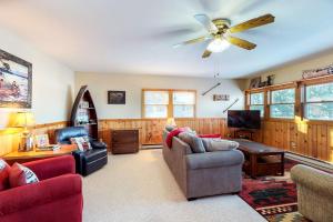 a living room filled with furniture and a ceiling fan at Briar's Hideaway in Phelps