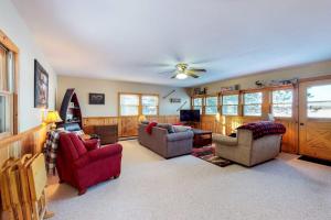 a living room with couches and a ceiling fan at Briar's Hideaway in Phelps