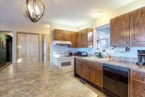 a kitchen with wooden cabinets and a counter top at Briar's Hideaway in Phelps +37 photos