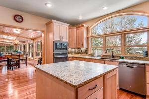 a kitchen with wooden cabinets and a large window at Casa Maria in Mercer