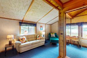 a living room with a couch and a chair at Catfish Cottage B in Eagle River +20 photos