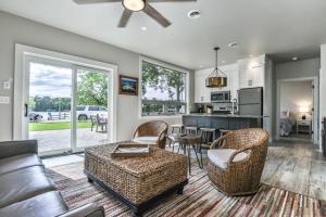 a living room with a couch and chairs and a kitchen at The Studio in Minocqua