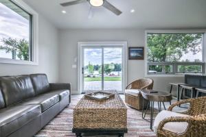 a living room with a leather couch and chairs at The Studio in Minocqua