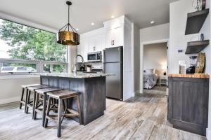 a kitchen with a island with stools and a counter top at The Studio in Minocqua