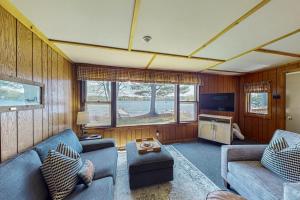 a living room with two couches and a tv at Catfish Cottage A in Eagle River