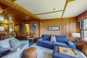 a living room with a blue couch and a table at Catfish Cottage A in Eagle River