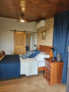 a bedroom with a bed and a table with a lamp at Hill Top Park - Apple Tree Studio in Kilmore