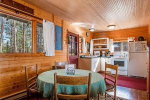 a kitchen and dining room with a table and chairs at Bucky's PineIsle Retreat in Three Lakes