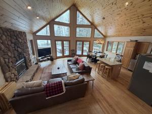 a large living room with a large stone wall at Sandy Cove in Saint Germain