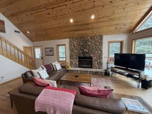 a living room with a couch and a fireplace at Sandy Cove in Saint Germain