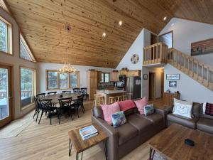a living room with a couch and a table at Sandy Cove in Saint Germain