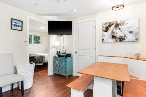 a living room with a table and a horse picture on the wall at Cove View in Minocqua