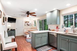 a kitchen with green cabinets and a ceiling fan at Cove View in Minocqua +18 photos