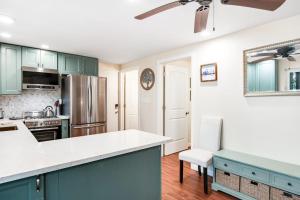 a kitchen with blue cabinets and a white counter top at Cove View in Minocqua