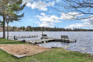 two benches sitting on a dock on a lake at Copperwood #1 in Eagle River