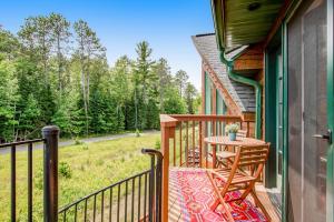 a balcony of a house with a table at Copperwood #4 in Eagle River