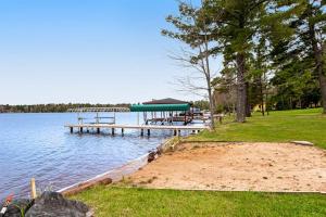 a dock with picnic tables on the shore of a lake at Copperwood #4 in Eagle River