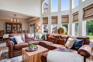 a large living room with a brown leather couch at Copperwood #4 in Eagle River