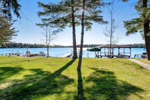 a park with picnic tables and a gazebo on a lake at Copperwood #4 in Eagle River