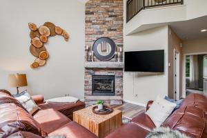 a living room with a couch and a fireplace at Copperwood #4 in Eagle River +26 photos
