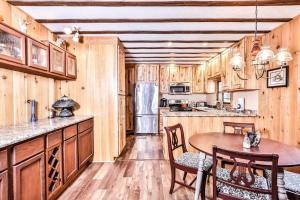 a kitchen with wooden cabinets and a table and chairs at Tranquility Base in Rhinelander