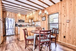a kitchen with a table and chairs and a refrigerator at Tranquility Base in Rhinelander