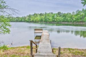 a dock in the middle of a lake at Northwoods Getaway in Arbor Vitae