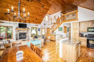 a kitchen and living room with a wooden ceiling at Northwoods Getaway in Arbor Vitae