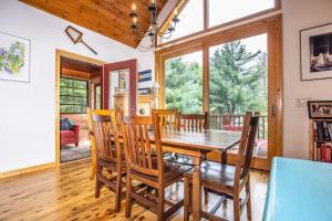 a dining room with a wooden table and chairs at Northwoods Getaway in Arbor Vitae