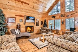 a living room filled with furniture and a fireplace at Shady Lane Lodge in Eagle River