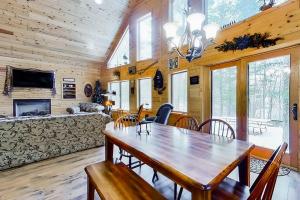 a dining room with a wooden table and chairs at Shady Lane Lodge in Eagle River +32 photos