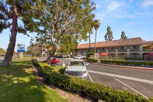 a car parked in a parking lot in front of a building at Good Nite Inn Camarillo in Camarillo