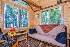 a living room with a couch and two windows at The Nut House in Eagle River
