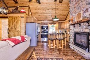 a living room with a couch and a fireplace at The Nut House in Eagle River