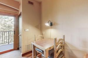 a dining room with a wooden table and a balcony at Chula Vista Condo Unit 2647 in Wisconsin Dells