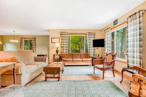 a living room with a couch and a table at Ashton House in Phelps