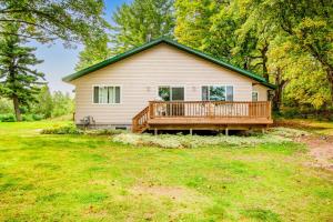 a house with a large deck on a yard at Ashton House in Phelps