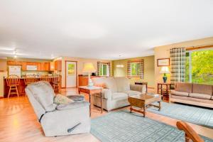 a living room filled with furniture and a kitchen at Ashton House in Phelps +24 photos