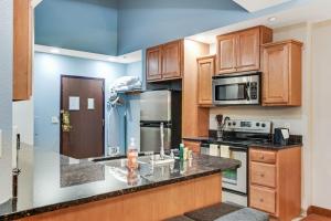 a kitchen with wooden cabinets and a counter top at Chula Vista Condo Unit #2145 in Wisconsin Dells