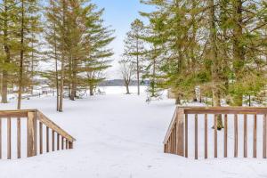 a wooden bridge in the snow with trees at The Haven in Eagle River