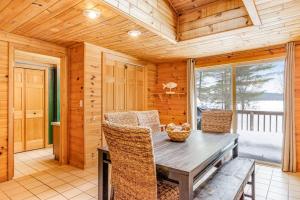 a dining room with a table and chairs in a cabin at The Haven in Eagle River