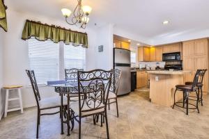 a kitchen and dining room with a table and chairs at Base Camp Eagle River in Eagle River