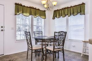 a dining room with a table and chairs and windows at Base Camp Eagle River in Eagle River +19 photos